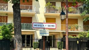 A street sign in front of a tall building